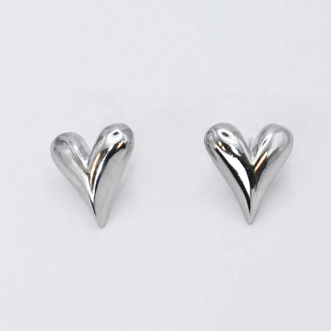 Heart-shaped silver earrings on a white background