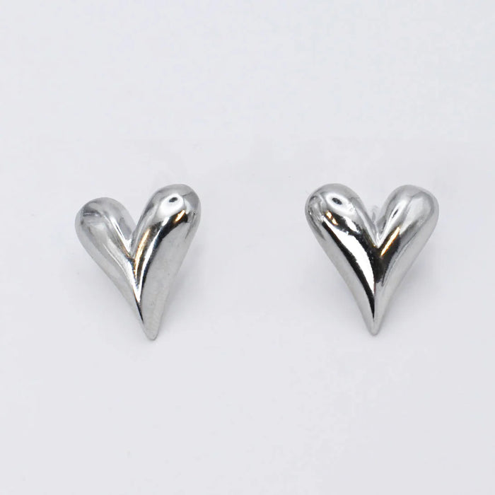 Heart-shaped silver earrings on a white background